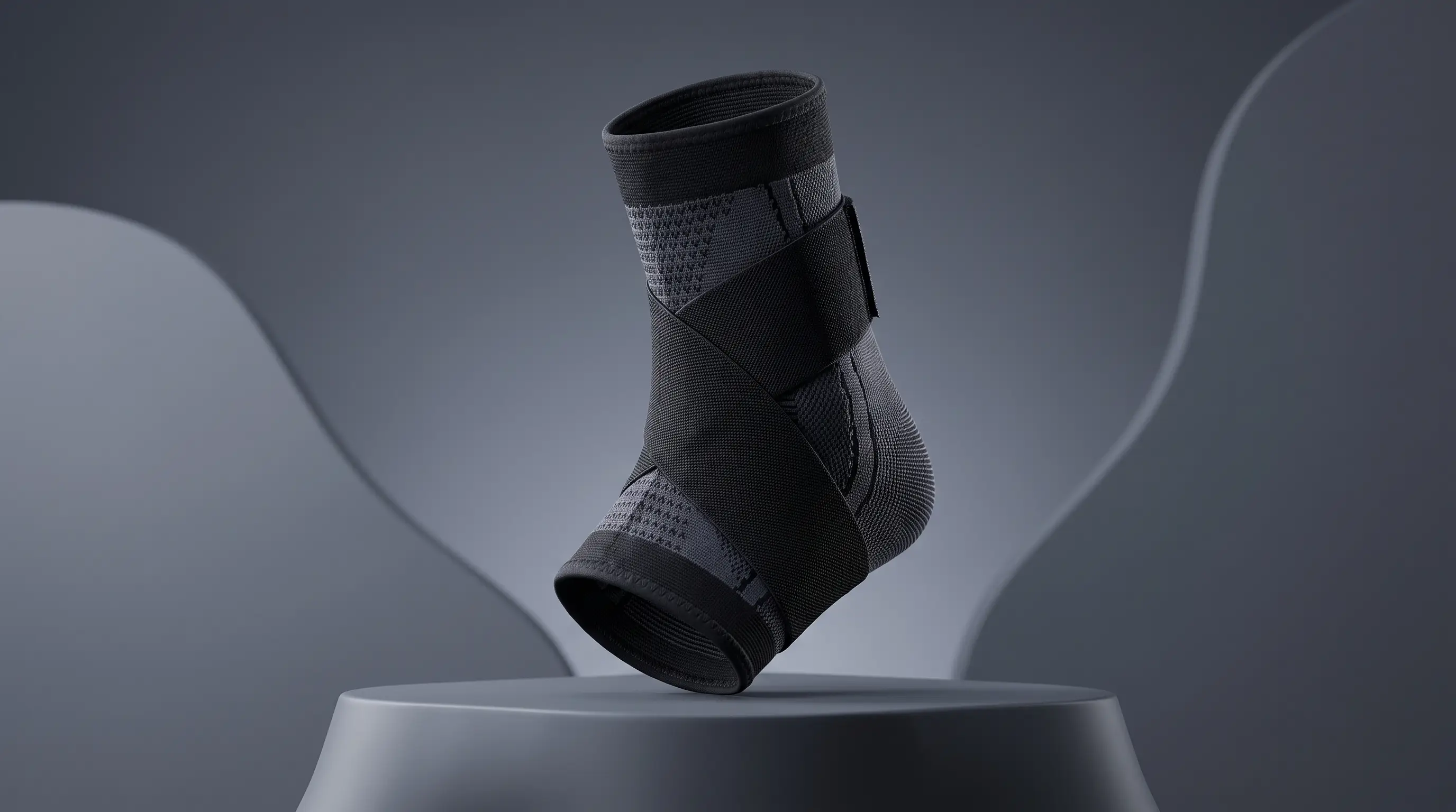 Black and grey ankle sleeve displayed against a charcoal studio background